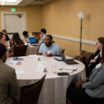 Staff attendees discuss teacher recruitment and retainment during the "Educator Workforce Policy" session.